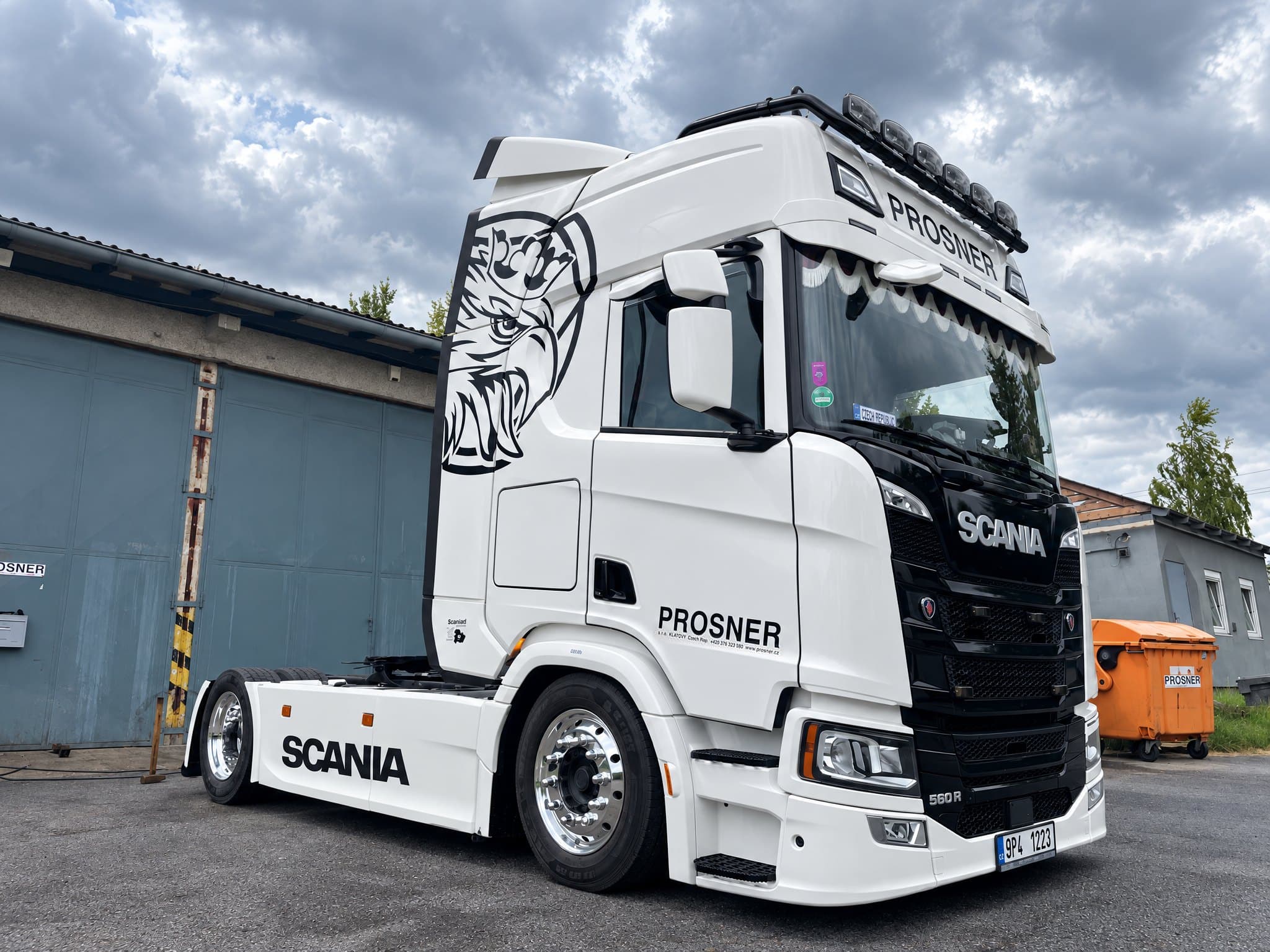 Bílý tahač Scania 560 R s nápisem PROSNER a gryfem na boku kabiny